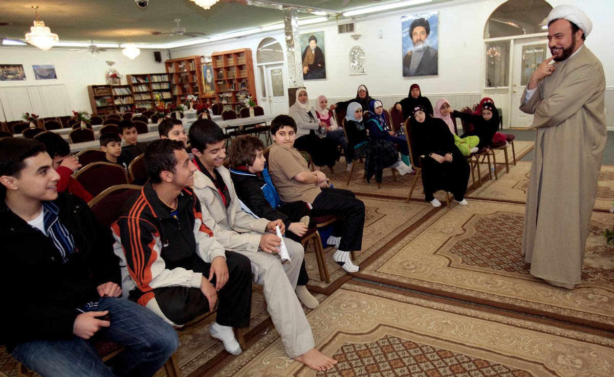 Imam Husham Al-Husainy (R) talks to Muslim youth about their experiences as young Muslims in America during a youth meeting at the Karbalaa Islamic Education Center in Dearborn, Michigan, March 13, 2010. A growing school of thought among counterterrorism specialists, and within the administration of U.S. President Barack Obama, argues that law enforcement should engage more deeply with the Muslim community. Their case has been bolstered by encouraging examples of outreach programs. Picture taken March 13. To match SPECIAL REPORT USA-SECURITY/HOMEGROWN  REUTERS/Rebecca Cook  (UNITED STATES - Tags: RELIGION POLITICS) (Reuters)