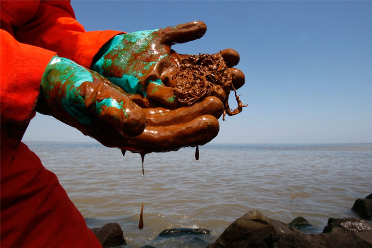 Oil drips from the rubber gloves of a Greenpeace Biologist at the mouth of the Mississippi River.