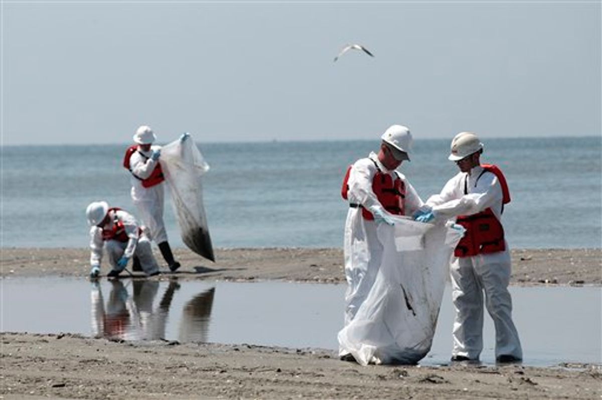 A group of workers clean the beach of oil residue from the Deepwater oil rig spill near Grand Isle, La., Thursday, May 27, 2010. (AP Photo/Jae C. Hong) (AP)