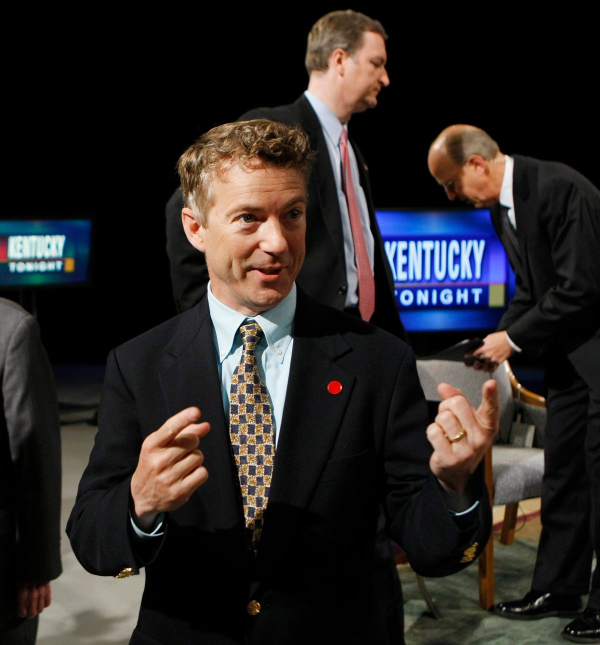 Republican U.S. Senate candidate Rand Paul talks with a person in the foreground as opponent C.M. "Trey" Grayson, top, and host Bill Goodman await the beginning of a televised candidate forum in Lexington, Ky., Monday, May 10, 2010.  (AP Photo/Ed Reinke)      (Ed Reinke)