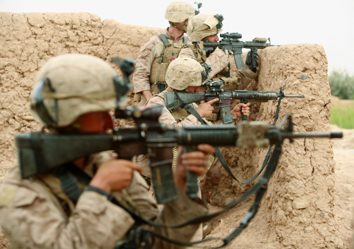 U.S. Marines from Lima Company 3rd Battalion, 6th Marines aim their weapons during a shootout with Taliban fighters in Karez-e-Sayyidi, in the outskirts of Marjah district, Helmand province, May 15, 2010. REUTERS/Asmaa Waguih (AFGHANISTAN - Tags: MILITARY CONFLICT)   (Reuters)