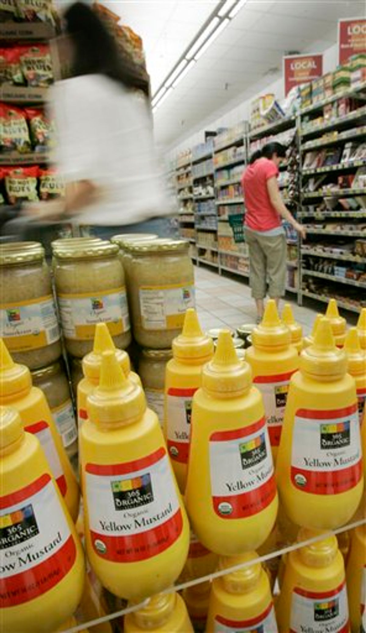 In this photo taken Tuesday, May 11, 2010, shoppers browse near a display of 365 Organic brand mustard at a Whole Foods Market, Inc., store in Little Rock, Ark. Whole Foods reports quarterly earnings, Wednesday, May 12, 2010, after the market close. 365 Organic is a Whole Foods brand. (AP Photo/Danny Johnston)       (AP)