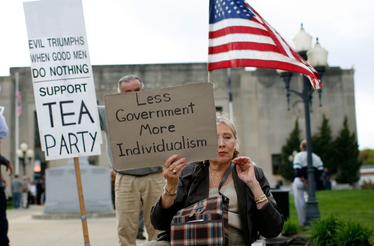 A woman holds a sign at a tax day rally by Tea Party activists in the New York City suburb of New City, New York, April 15, 2010. April 15 is the deadline for filing tax returns in the U.S.  REUTERS/Mike Segar  (UNITED STATES - Tags: BUSINESS POLITICS)      (Reuters)