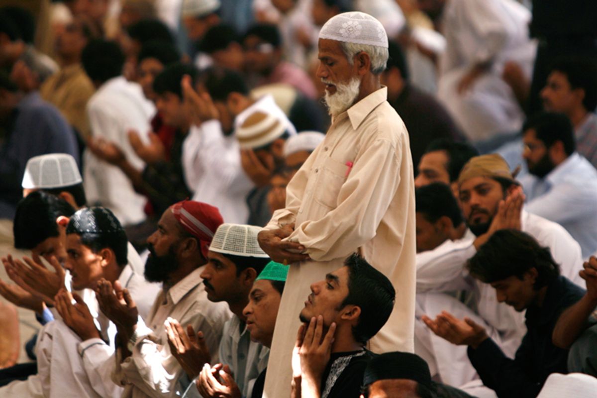 A man stands as he prays in a mosque in Karachi, Pakistan.
