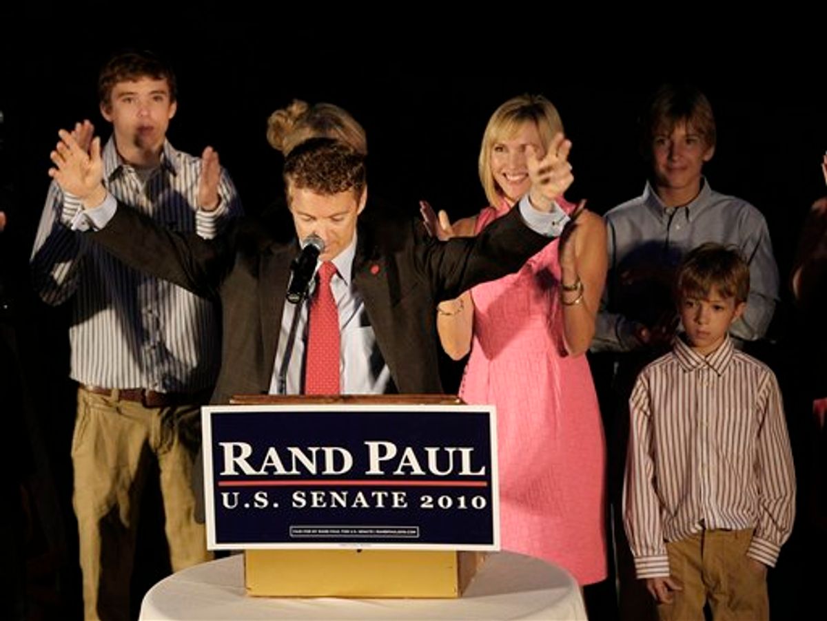 Republican U.S. Senate candidate Rand Paul raises his arms to the cheers of supporters at his victory party in Bowling Green, Ky., Tuesday, May 18, 2010. At left is Paul's son William. At right is his wife Kelley and sons Duncan, top, and Robert.  (AP Photo/Ed Reinke) (Associated Press)