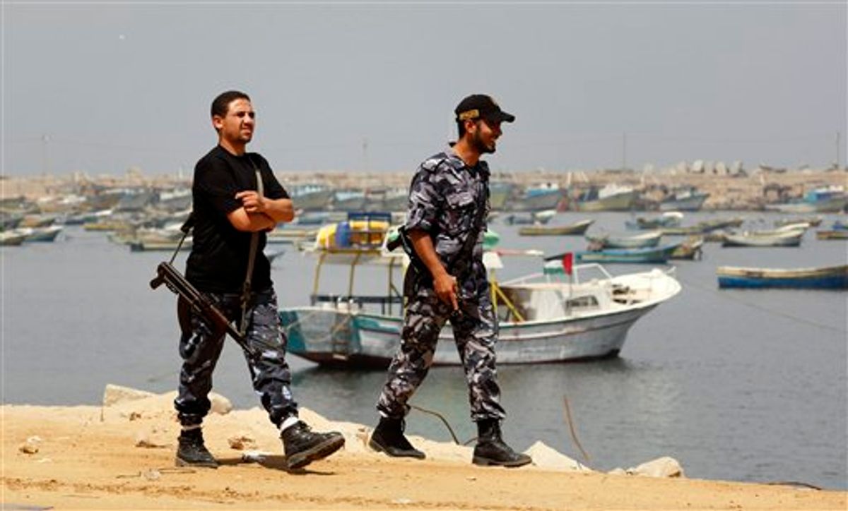 Hamas security officers patrol on Gaza's seaport, Tuesday, June 1, 2010. Palestinians in Gaza declared a general strike and a day of wrath following Israel's deadly naval raid on an aid flotilla bound for the blockaded Gaza Strip on Monday. (AP Photo/Hatem Moussa) (AP)