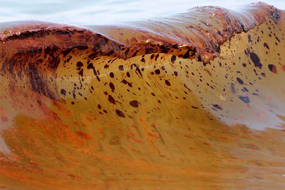 A wave polluted with crude from the Gulf oil spill washes ashore in Orange Beach, Ala., Saturday.   