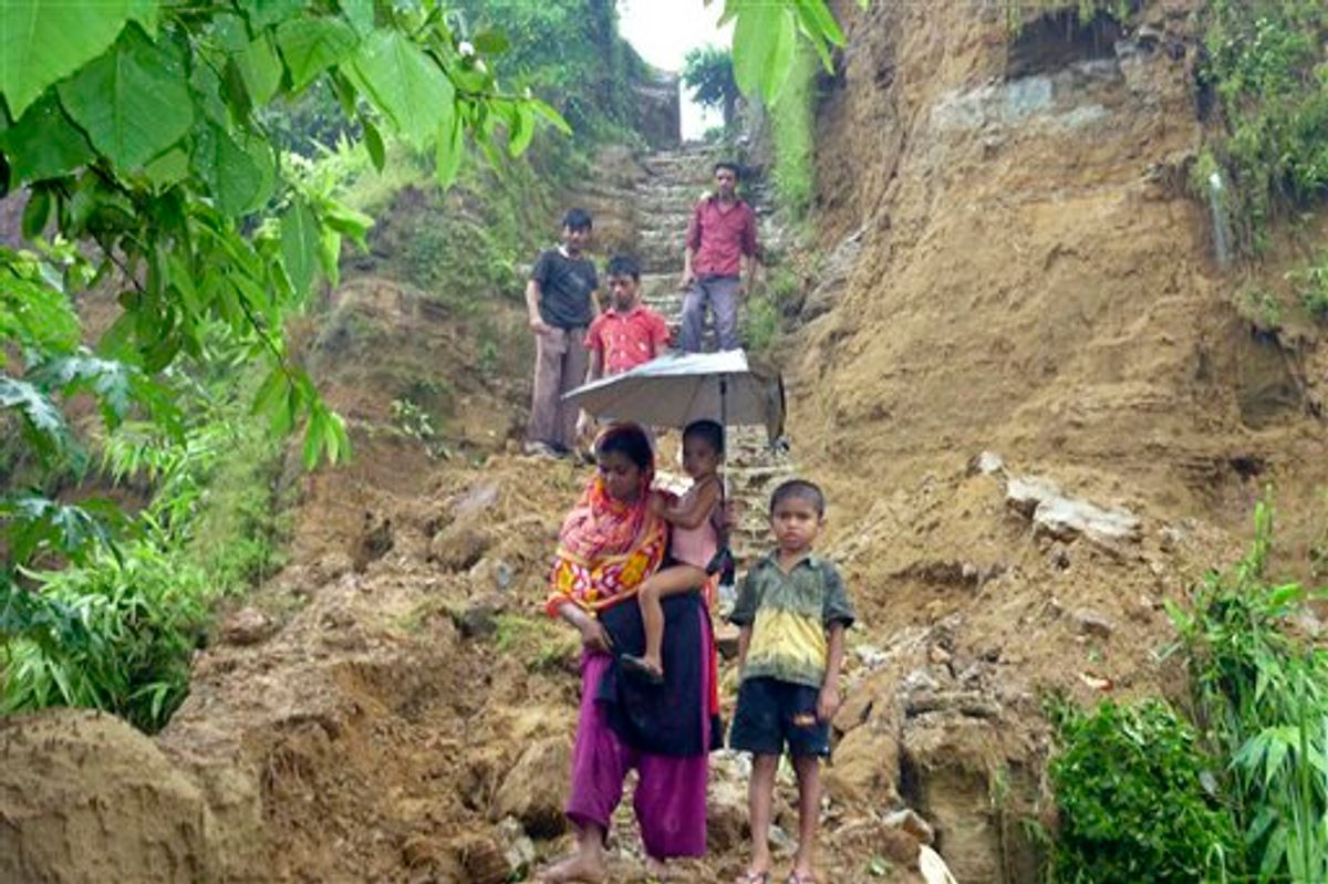 Bangladeshi villagers walk down from their hilltop home after landslides struck in the southern coastal area of Cox's Bazar, 185 miles (296 kilometers) south of Dhaka, Bangladesh, Tuesday, June 15, 2010. Powerful landslides triggered by heavy rains killed at least 38 people and left seven army soldiers missing in southeastern Bangladesh. (AP Photo/Tofayel Ahmed)        (AP)