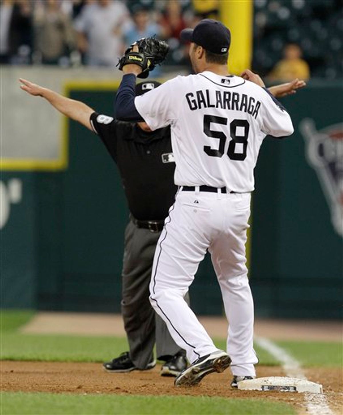 Detroit Tigers pitcher Armando Galarraga (58) looks at first base umpire Jim Joyce (partially obscured) who called Cleveland Indians' Jason Donald safe in the ninth inning of a baseball game in Detroit, Wednesday, June 2, 2010. Galarraga lost his bid for a perfect game with two outs in the ninth inning on the disputed call at first base. Detroit won 3-0. (AP Photo/Paul Sancya) (AP)