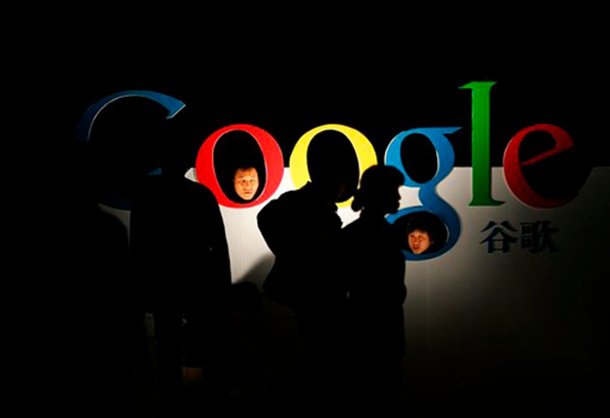 FILE - In this April 12, 2006 file photo, Chinese poke their heads through a Google logo shortly after Google debuts its Chinese Language brand name in the Beijing Hotel in Beijing. Google Inc. said Tuesday, June 29, 2010, it will stop automatically rerouting users of its China search site to its Hong Kong site after Beijing said the company would lose its mainland Internet license if the tactic continued. (AP Photo/Elizabeth Dalziel, File) (Elizabeth Dalziel)