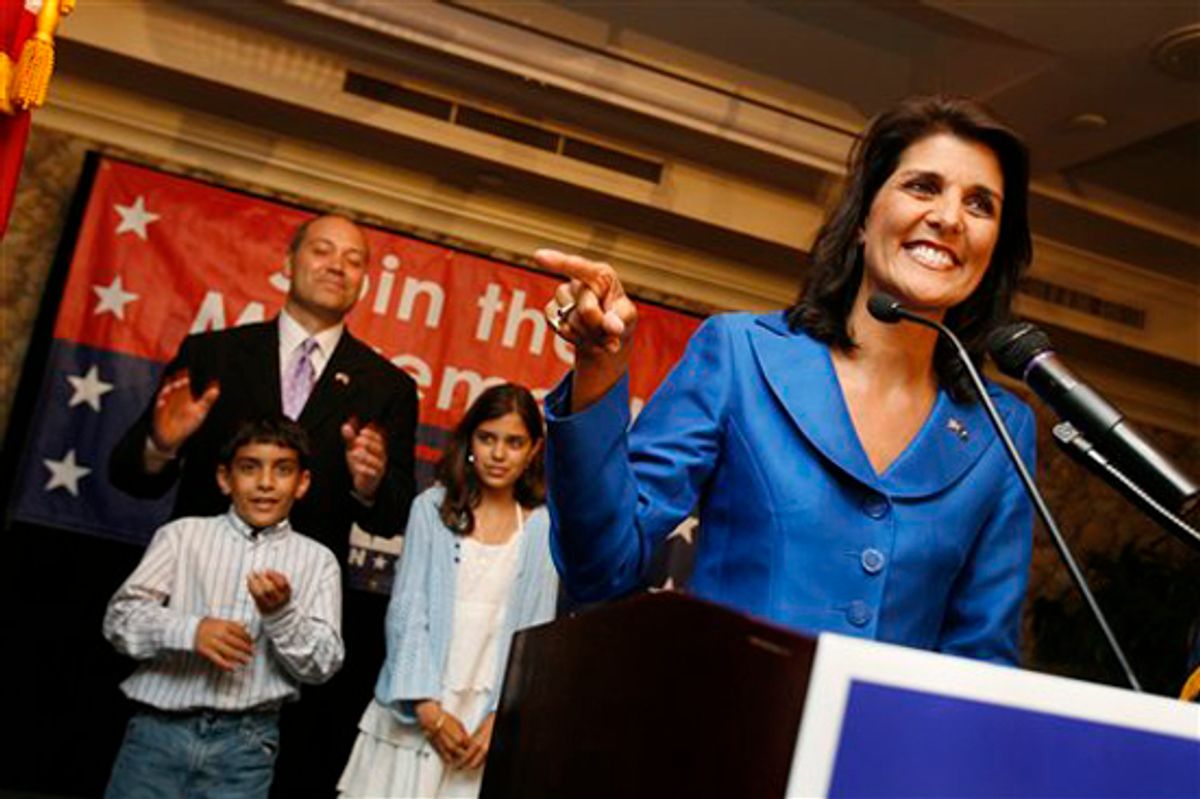 Rep. Nikki Haley, R-Lexington,who garnered the most votes in the GOP gubernatorial primary  gives a victory speech to supporters at the Capital City Club in Columbia, S.C., on Tuesday, June 8, 2010.  Haley will face Rep. Gresham Barrett in a runoff election in two weeks for the GOP nomination.   Her husband Michael, son Nalin and daughter Rana stand behind her. (AP Photo/Rich Glickstein/The State) (Rich Glickstein)