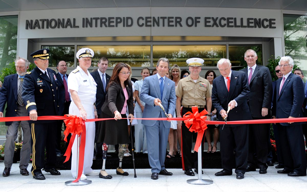 Richard Santulli, chairman of the Intrepid Fallen Hero Fund, holding scissors at center, and Arnold Fisher, honorary chairman of the Intrepid Fallen Hero Fund, with scissors third from right, cut the ribbon during the dedication of the National Intrepid Center of Excellence at the National Naval Medical Center in Bethesda, Md., Thursday, June 24, 2010. Also participating in the event is Assistant Veterans Affairs Secretary Tammy Duckworth, with cane.  (AP Photo/Susan Walsh)  (Susan Walsh)