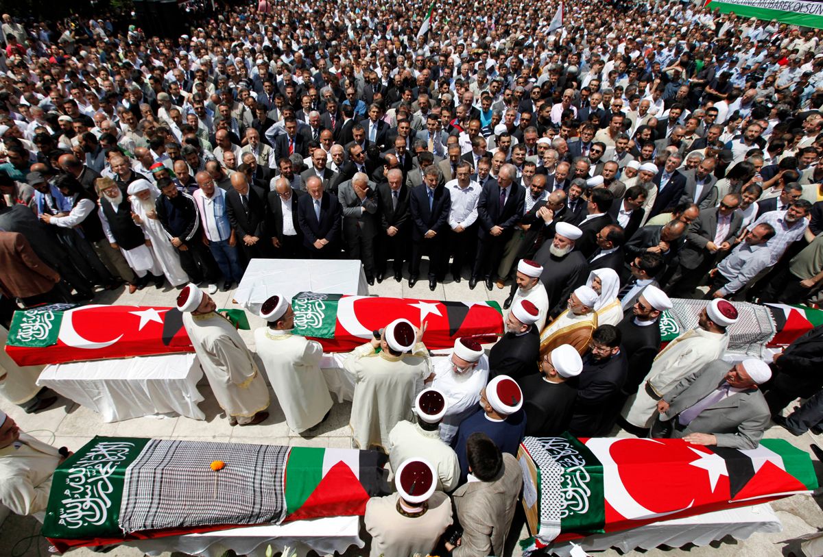 Imams and mourners pray behind the Turkish flag-wrapped coffins of activists, who were killed when Israel seized a Turkish aid ship bound for Gaza, during a funeral ceremony at Fatih mosque in Istanbul June 3, 2010. REUTERS/Murad Sezer (TURKEY - Tags: POLITICS CIVIL UNREST) (Â© Murad Sezer / Reuters)