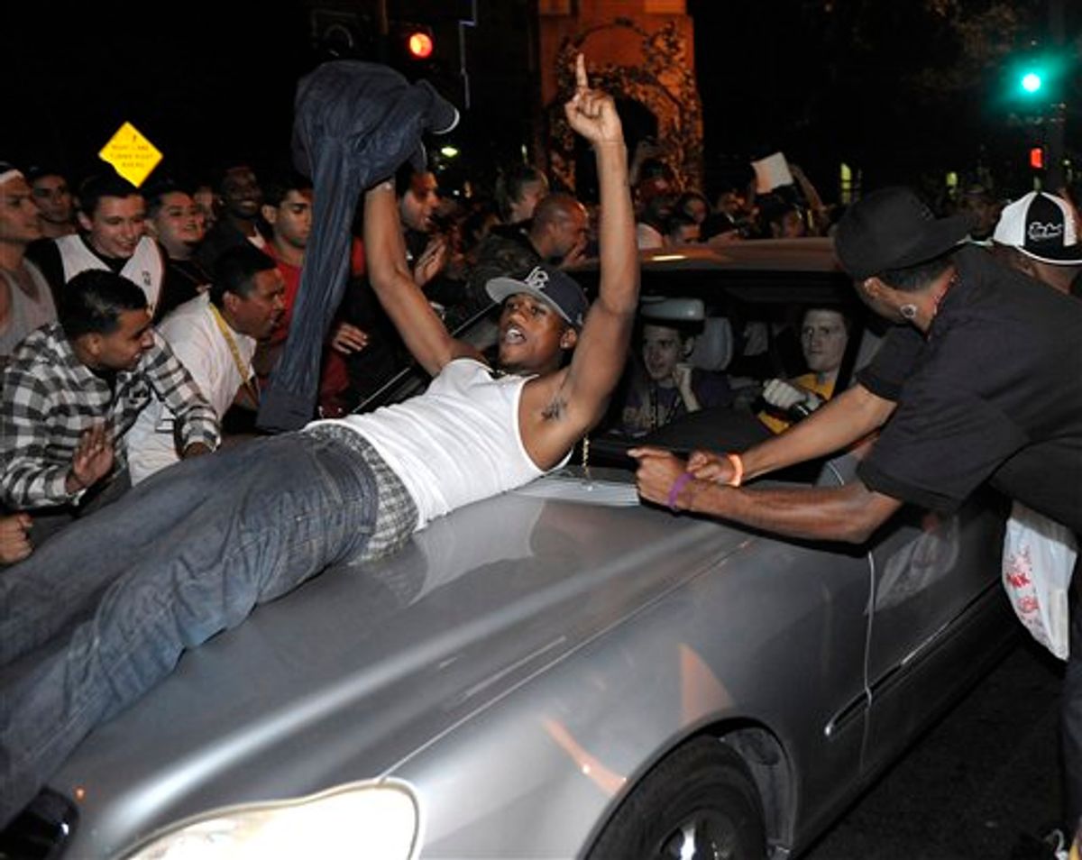 Los Angeles Laker fans celebrate while police try to control a crowd on the street outside the Staples Center in Los Angeles after Game 7 of the NBA finals on Thursday, June 17, 2010.  (AP Photo/Dan Steinberg) (AP)