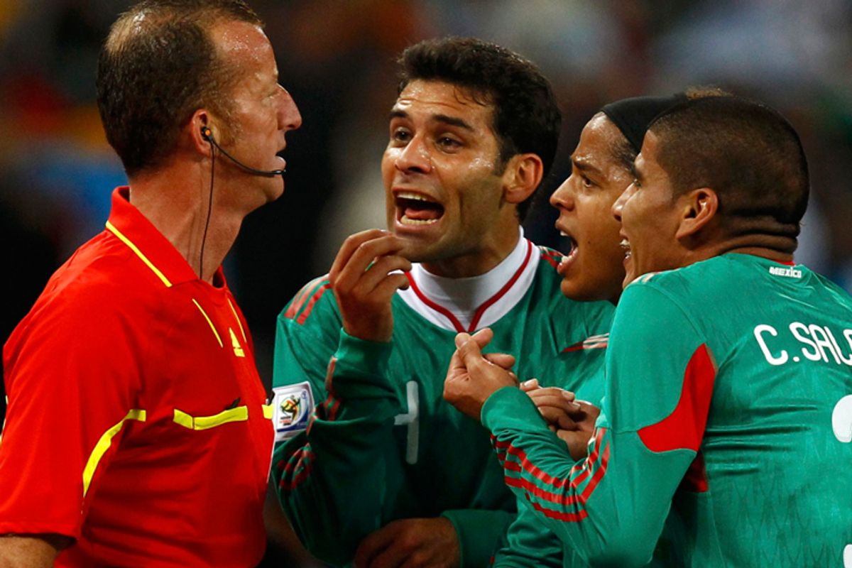 Mexican players plead with referee Roberto Rosetti to overturn a goal scored by Argentina's Carlos Tevez Sunday. Replays showed Tevez was offside.
 
