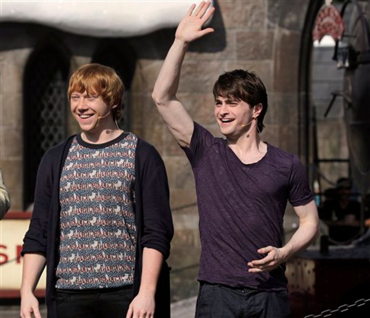 Actors Rupert Grint, left, and Daniel Radcliffe greet fans at the grand opening of the Wizarding World of Harry Potter at Universal Orlando theme park in Orlando, Fla., Friday, June 18, 2010.(AP Photo/John Raoux) (AP)