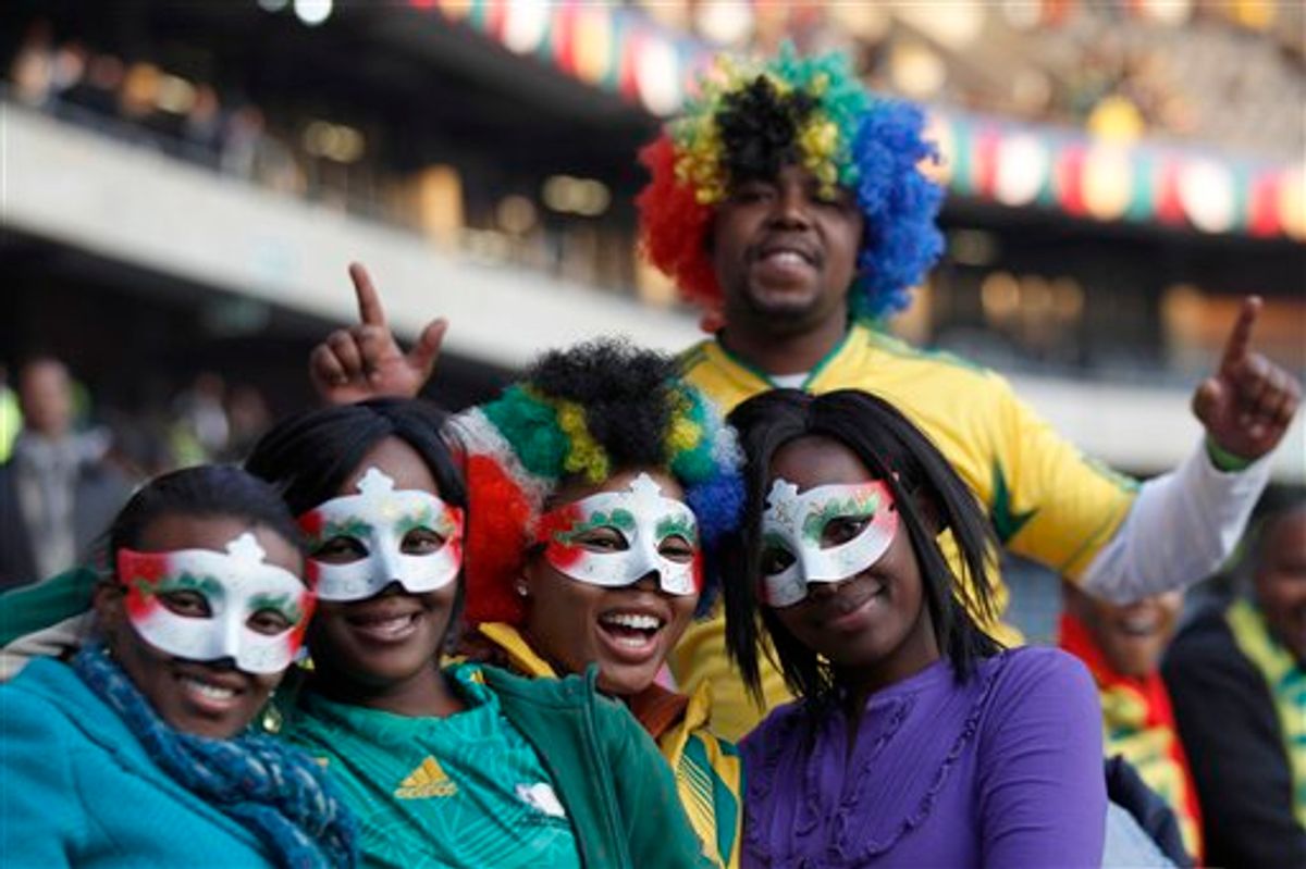 South African soccer fans pose for pictures during the opening concert for the soccer World Cup at Orlando stadium in Soweto, Johannesburg, South Africa, Thursday, June 10, 2010.  The soccer World Cup  will start on Friday, June 11. (AP Photo/Hassan Ammar) (AP)