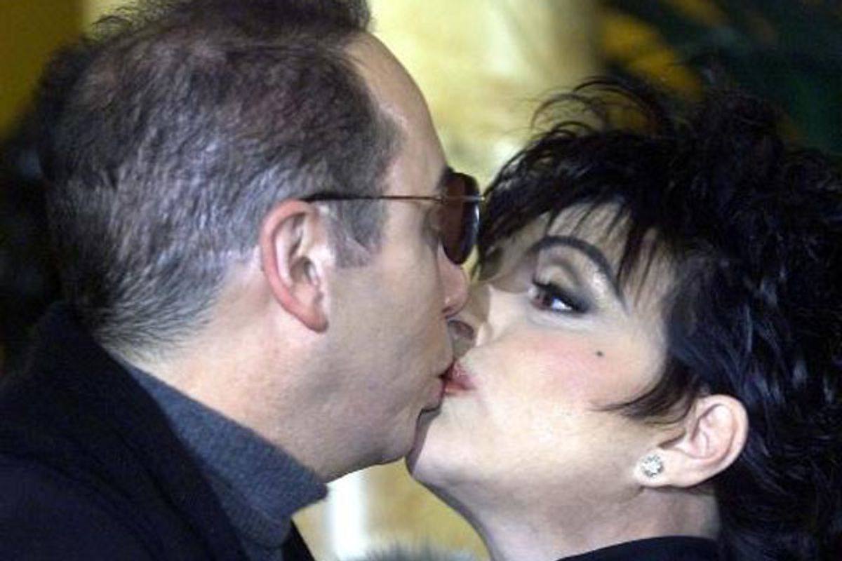 American actress and singing star Liza Minnelli kisses her fiance David Gest at a press conference in London Thursday, Jan. 24, 2002. Minnelli was due to announce her return to the concert stage, with a major European tour that will start at the Royal Albert Hall in London in April 2002. (AP Photo/Dave Caulkin)  (Dave Caulkin)