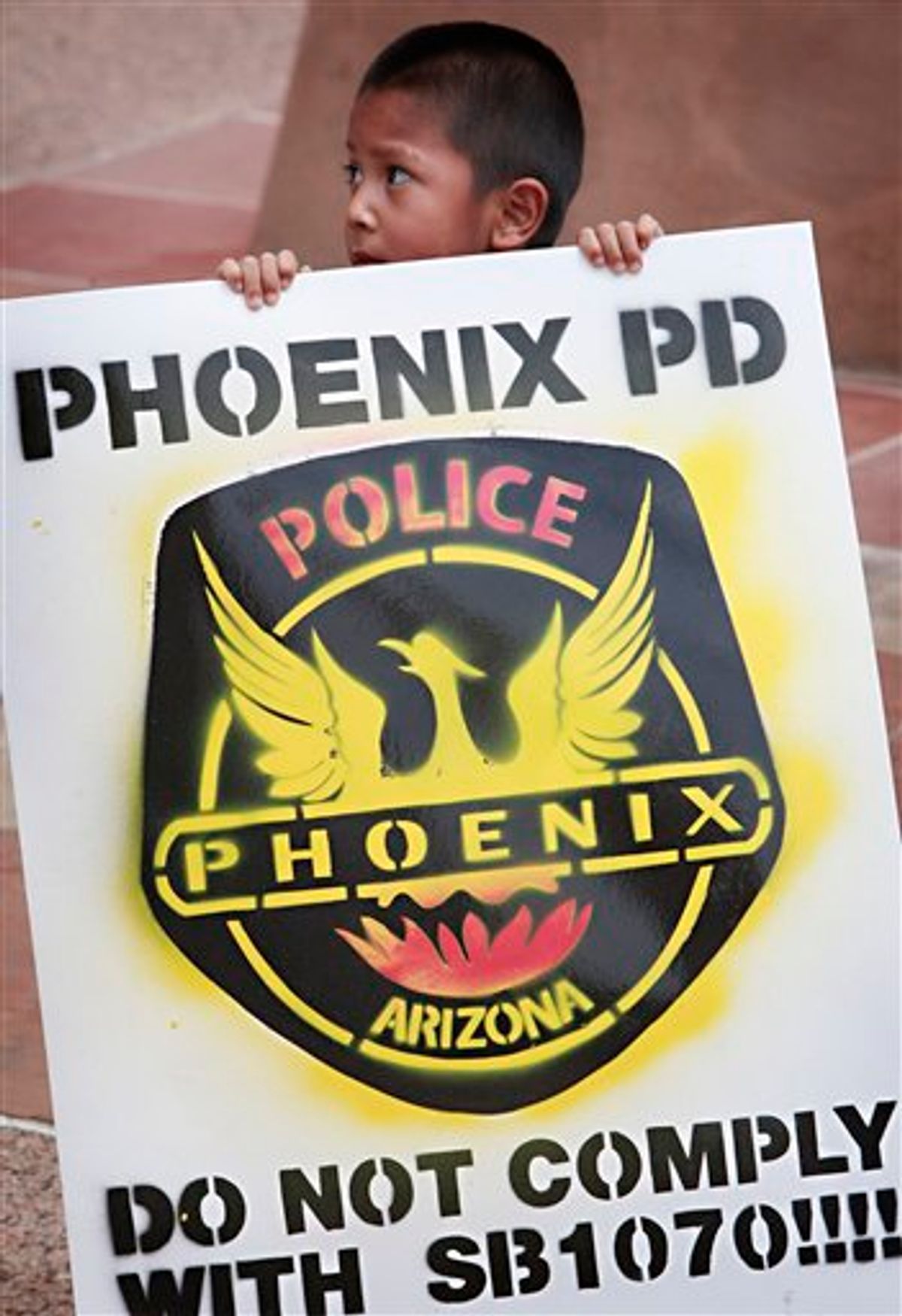 David Castillo, 3, stands with family members outside City Hall Tuesday, July 27, 2010 in Phoenix. Community members from the Puente Movement were petitioning the city to not enforce Arizona's immigration bill, SB 1070, which takes effect Thursday, July 29th. (AP Photo/Matt York) (AP)