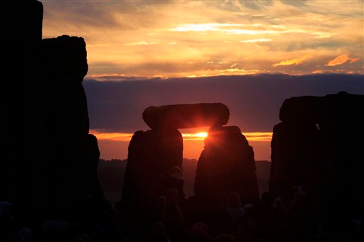 The sun is rising behind the Stonehenge monument in England, during the summer solstice shortly after 04:52 am, early Monday, June 21, 2010. Druids, pagans and partygoers crammed into the mystic stone circle to cheer, bang drums and shake tambourines in an effort to greet the sun on the longest day of the year in the northern hemisphere, the summer solstice. Stonehenge, on the Salisbury Plain about 140 kilometers (90 miles) southwest of London, was built over three phases between 3,000 B.C. and 1,600 B.C. It is one of Britain's most popular tourist attractions; more than 750,000 people visit every year. (AP Photo/Lefteris Pitarakis) (AP)