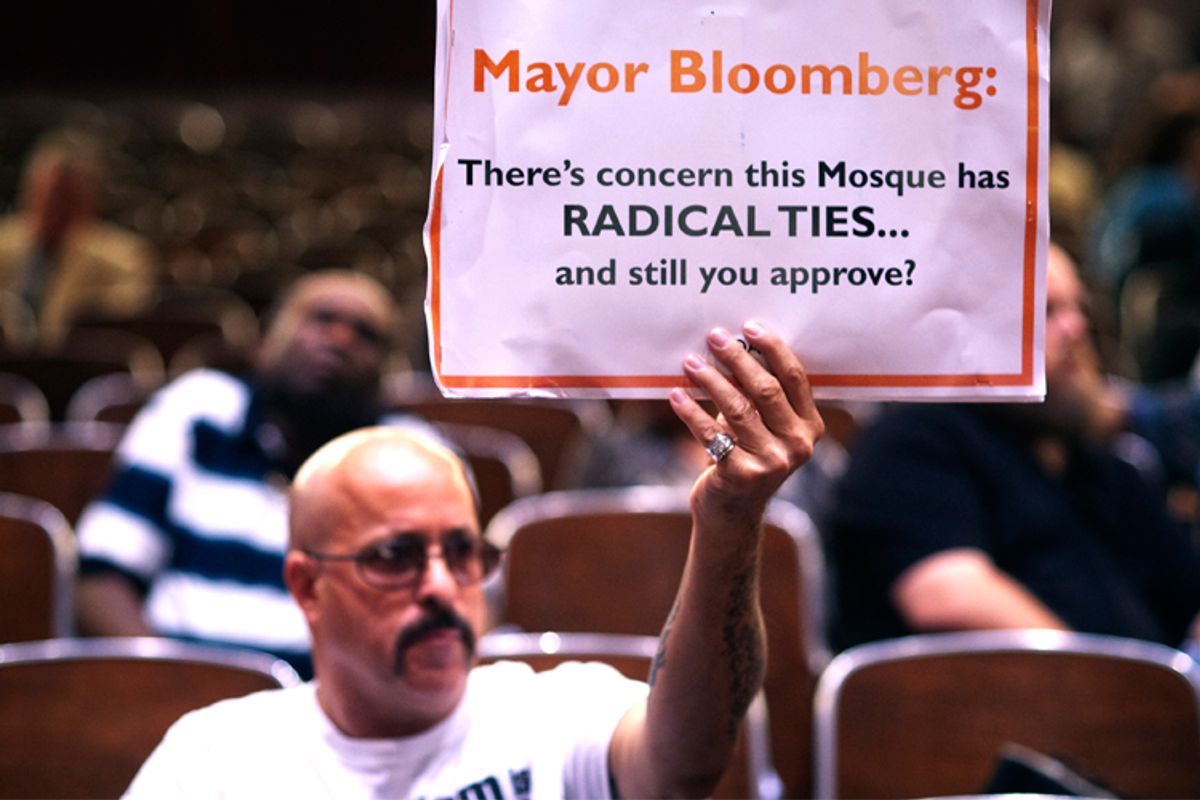 A demonstrator holds a sign during a Landmarks Commission hearing on the proposed Cordoba Mosque to be built near the site of the former World Trade Center.
