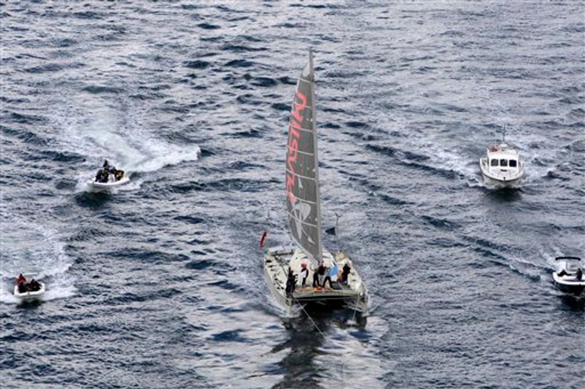The Plastiki, a boat made out of 12,500 recycled plastic bottles, sails on Sydney Harbour Monday, July 26, 2010, four months after it set out from San Francisco on a journey across the Pacific Ocean meant to raise awareness about the perils of plastic waste. The 60-foot (18.2 meter) catamaran that weathered fierce ocean storms during its 8,000 nautical miles at sea, left San Francisco on March 20, stopping along the way at various South Pacific island nations including Kiribati and Samoa. (AP Photo/Rick Rycroft) (AP)