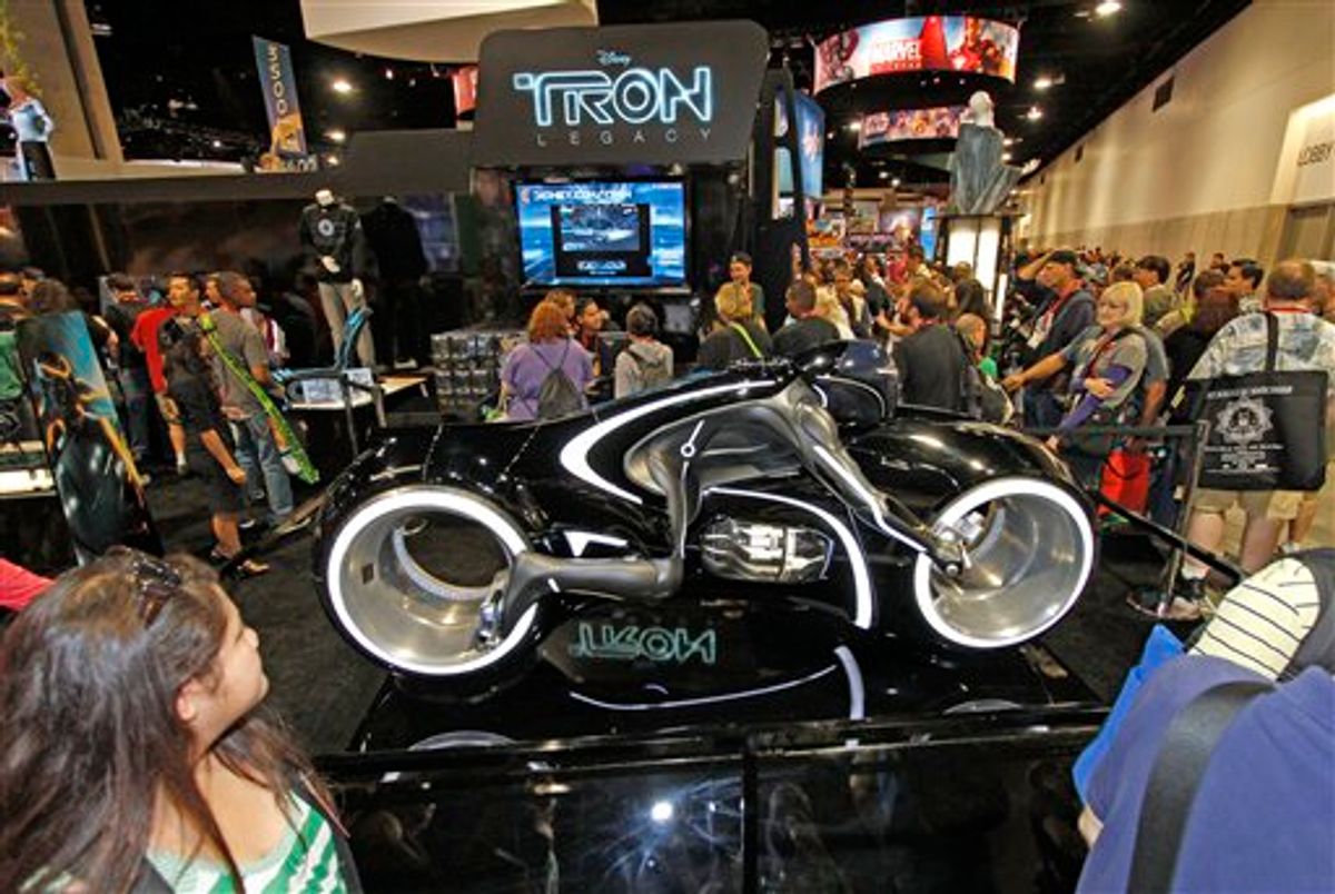Comic-Con attendees wait in line next to a motorcycle promoting the movie "Tron"  at  the preview night for  Comic-Con International Wednesday, July 21, 2010 in San Diego.  (AP Photo/Denis Poroy) (AP)