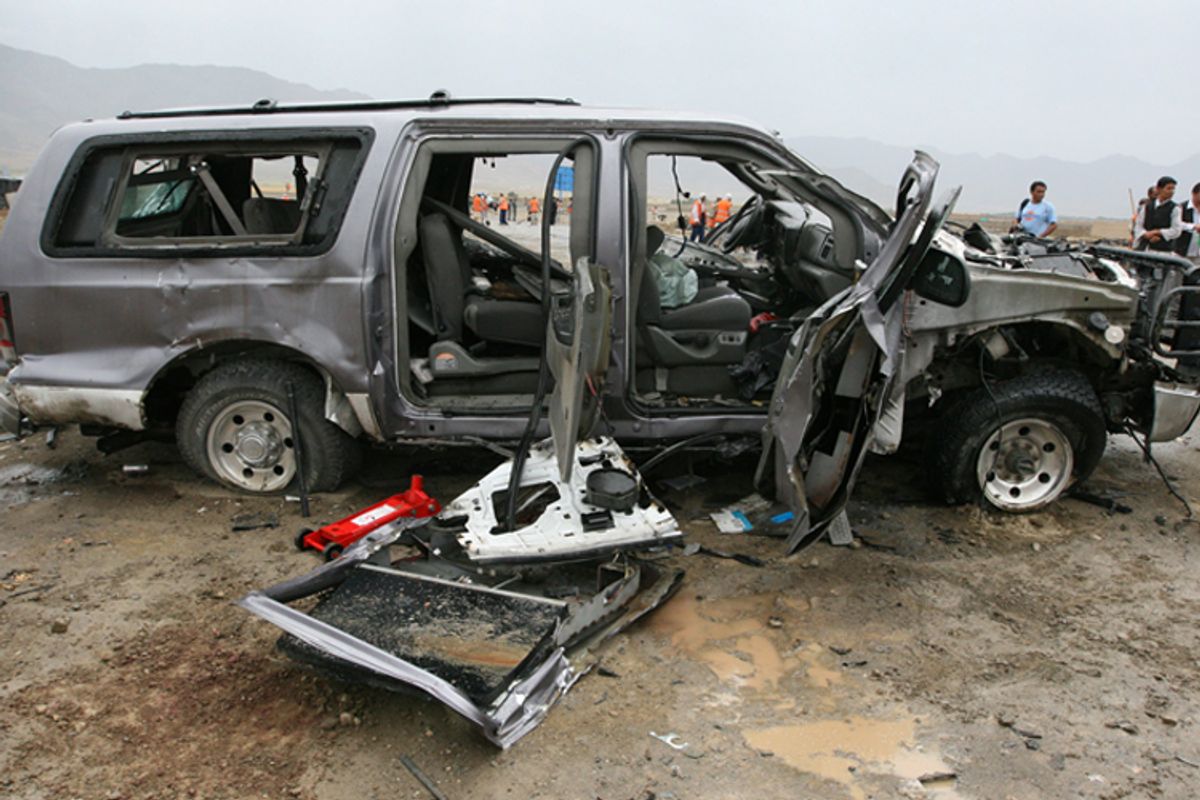 A contractor's vehicle is destroyed after a suicide car bomb attack on the outskirts of Kabul. 