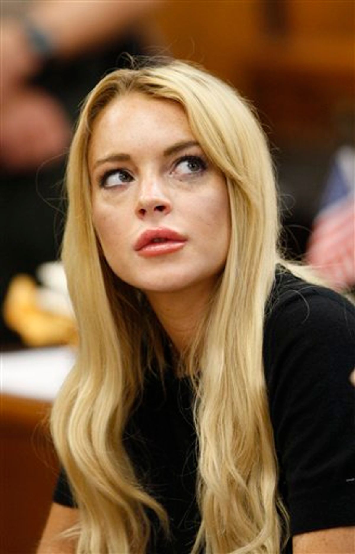 FILE - In this July 6, 2010 file photo, actress Lindsay Lohan appears in a courtroom for a probation revocation hearing in Beverly Hills, Calif. Lohan is scheduled to turn herself in Tuesday, July 20, to begin serving a 90 day jail sentence for violating the terms of her probation for a 2007 drug case. (AP Photo/David McNew, Pool) (AP)