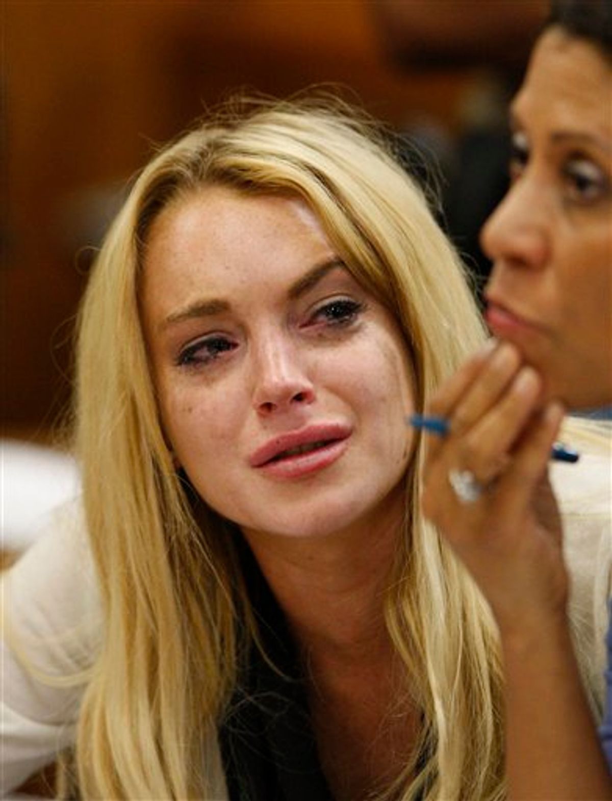 Actress Lindsay Lohan, left, reacts with her attorney Shawn Chapman Holley after the sentencing by Superior Court Judge Marsha Reve during a hearing in Beverly Hills, Calif., Tuesday, July 6, 2010. The judge sentenced Lindsay Lohan to 90 days in jail Tuesday after ruling she violated probation in a 2007 drug case by failing to attend court-ordered alcohol education classes. (AP Photo/David McNew, Pool) (AP)