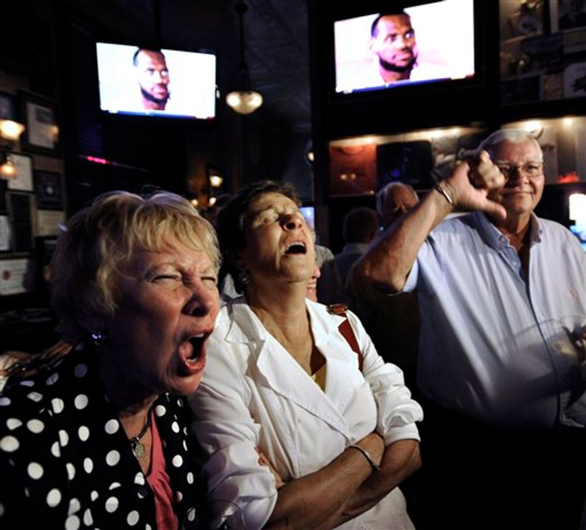Chicago Bulls fans Marianne Gilligan, left, Ann Deignan, middle, and Ed Gilligan react while watching LeBron James announce on television that he will play for the Miami Heat, at Harry Caray's restaurant in Chicago, Thursday, July 8, 2010. (AP Photo/Paul Beaty)   (AP)