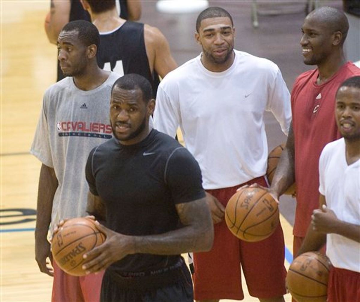 NBA free-agent LeBron James, foreground, is shown with Christian Eyenga, rear left, James friend Romeo Travis, white shirt, Jawad Williams, red shirt and Damon Jones, right, during a workout at the LeBron James Skills Academy for high school and college basketball players as a group of high school players watch, at Rhodes Arena on the University of Akron campus, in Akron, Ohio, Monday, July 5, 2010. (AP Photo/Phil Long) (AP)