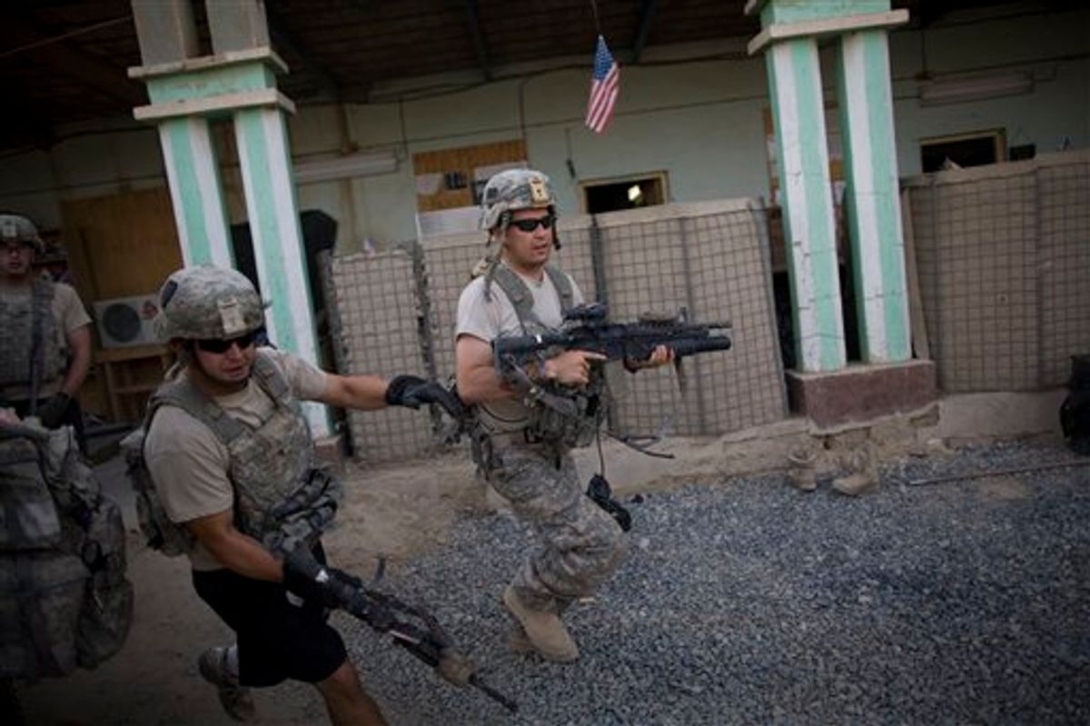 US soldiers from 1-320th Alpha Battery, 2nd Brigade of the 101st Airborne Division, run to firing positions after coming under attack by Taliban insurgents at COP Nolen, in the volatile Arghandab Valley, Kandahar, Afghanistan, Tuesday, July 27, 2010. (AP Photo/Rodrigo Abd) (AP)