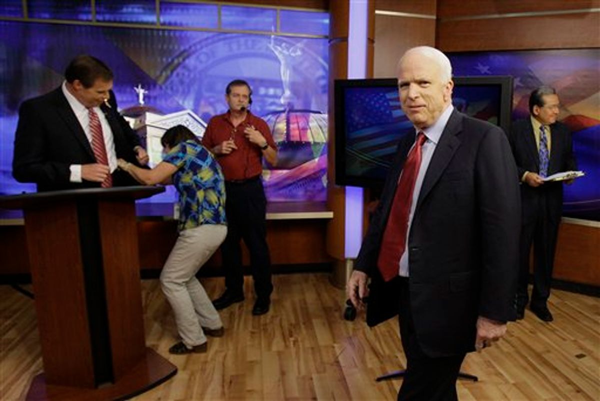 Sen. John McCain, right, arrives for the first Arizona Senate Republican debate at KTVK Channel 3 as former congressman J.D. Hayworth, left, stands at his debate podium, Friday, July 16, 2010, in Phoenix. The election primary is August 24. (AP Photo/Ross D. Franklin) (AP)