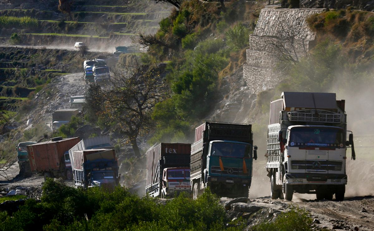 A convoy of Afghan trucks carrying wheat and US military supplies travels through Kunar Province in eastern Afghanistan December 28, 2008. REUTERS/Bob Strong  (AFGHANISTAN)    (Â© Bob Strong / Reuters)