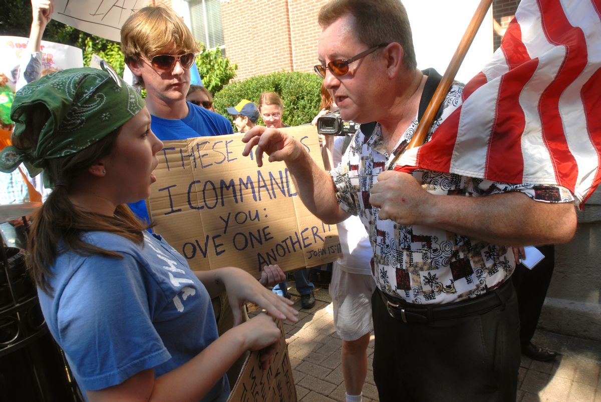 Protester Greg Johnson, right, and counter protesters Ina Marshall and Tim Foster, left, argue during demonstration against a planned mosque and Islamic community center on Wednesday, July 14, 2010 in front of the Rutherford County Courthouse in Murfreesboro, Tenn. Those opposing the mosque circulated a  petition asking the county commission to rescind approval of the facility. (AP Photo/Christopher Berkey) (Christopher Berkey)