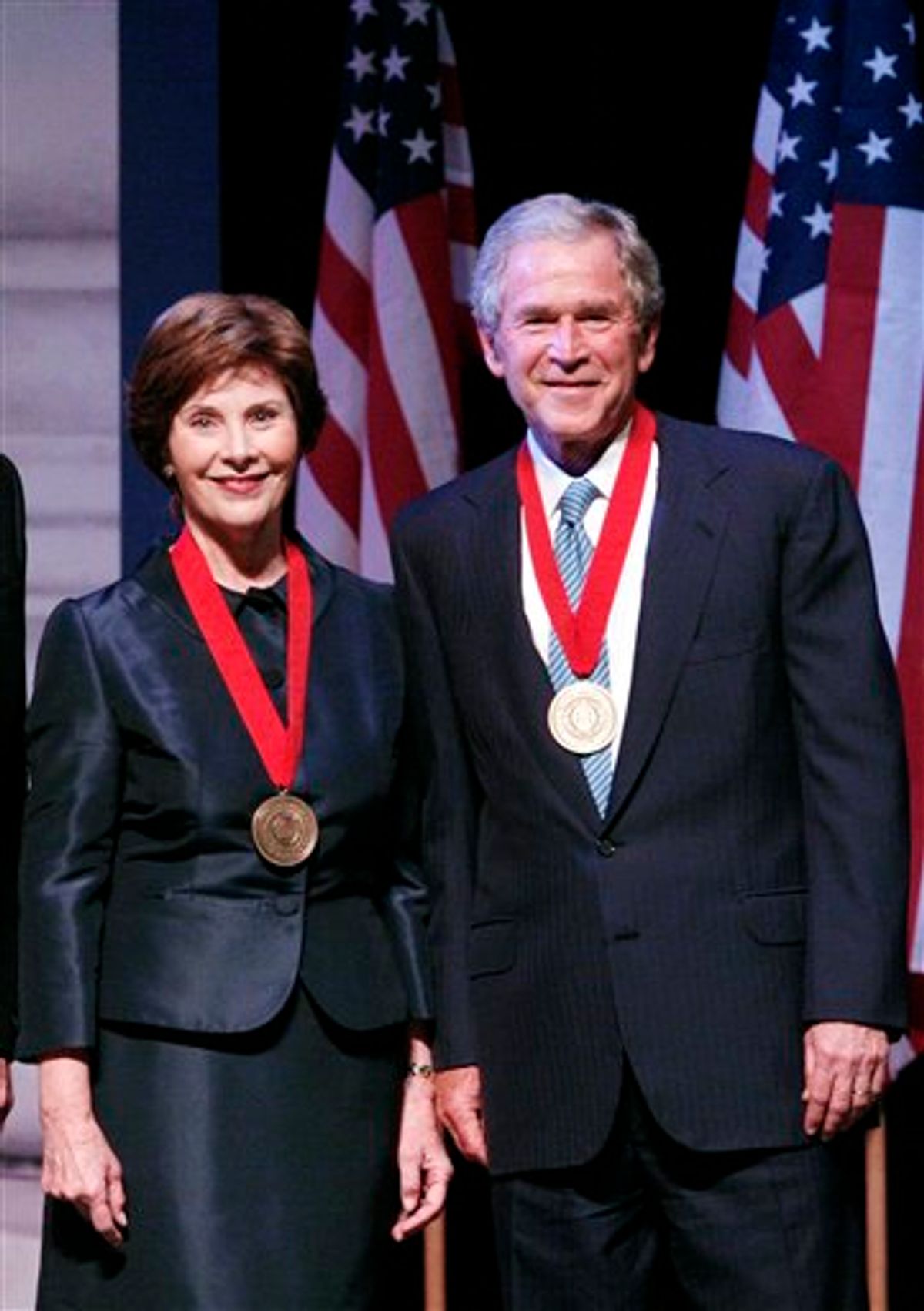 Former President George W. Bush and former First Lady Laura W. Bush pose for photographs after receiving the Southern Methodist University John Goodwin Tower Center Medal of Freedom Wednesday, April 21, 2010 in Dallas. (AP Photo/Amy Gutierrez) (AP)