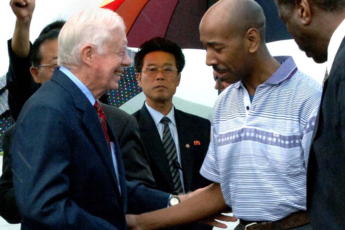 Former U.S. President Jimmy Carter, left, and Aijalon Gomes, second right, as they prepare to leave North Korea on Friday.