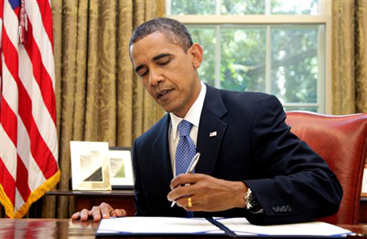 President Barack Obama signs emergency unemployment benefits legislation in the Oval Office of the White House, Thursday, July 22, 2010, Washington. (AP Photo/Carolyn Kaster) (Carolyn Kaster)