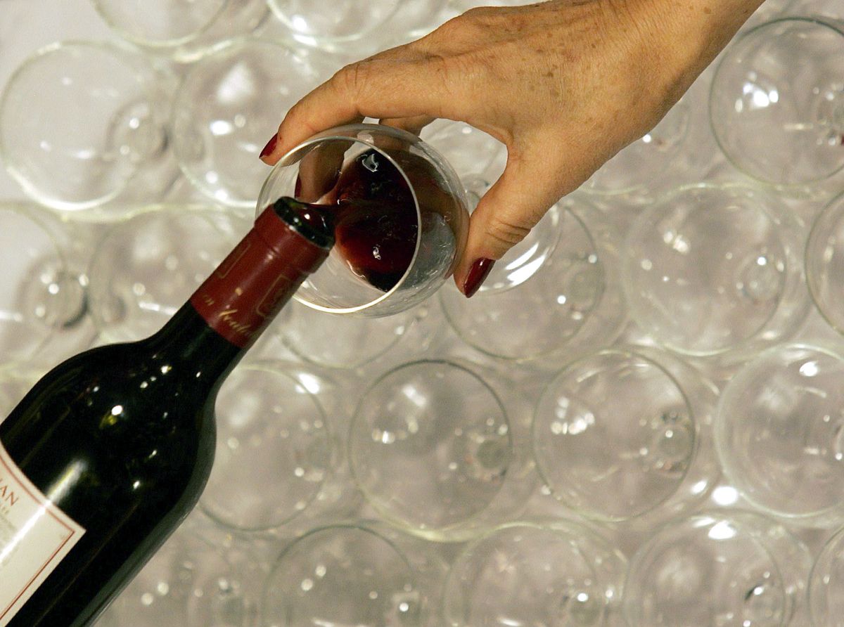 A woman tastes red wine in the Millesima cellar in Bordeaux, southwestern France, November 6, 2007.  REUTERS/Regis Duvignau (FRANCE)  (Â© Regis Duvignau / Reuters)