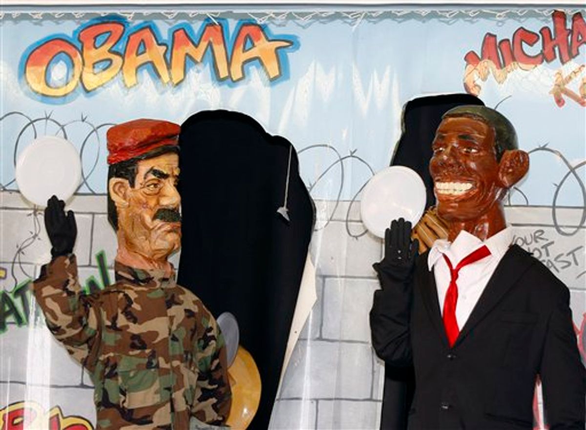 Caricatures of Saddam Hussein, left, and President Barack Obama are seen at a boardwalk game Tuesday, Aug. 10, 2010, in Seaside Heights, N.J. The game in the town where the MTV reality show "Jersey Shore" is filmed features a caricature of Obama, depicted with exaggerated ears and smile, as a moving target along with likenesses of Saddam Hussein, Osama bin Laden and Michael Jackson, The Joker and other characters. (AP Photo/Mel Evans) (AP)