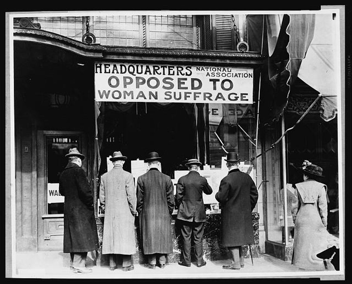 Men looking in the window of the National Anti-Suffrage Association headquarters circa 1911.