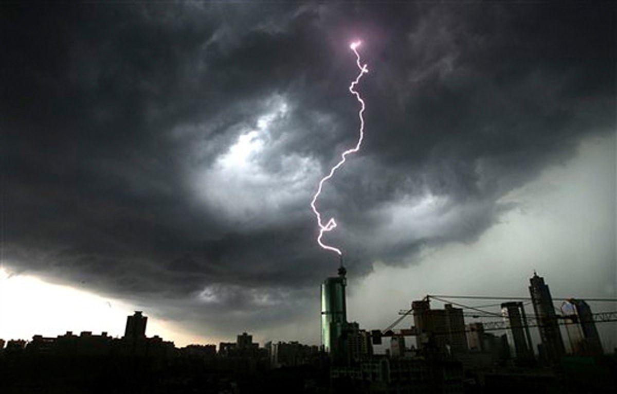 Lightning strikes the top of a building in Foshan in south China's Guangdong province in June. Torrential rains brought down a dike in southern China, forcing 68,000 people to flee their homes.
