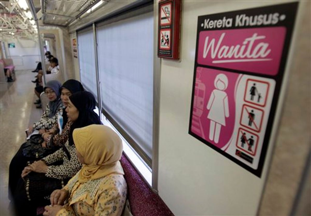 Indonesian women board a women-only carriage of a commuter train at a station during its launching ceremony in Depok, West Java, Indonesia, Thursday, Aug. 19, 2010. An Indonesian train operator launched women-only carriages as a new service following complaints about pinching, groping and unwanted advances. The sign reads "Special train for women". (AP Photo/Irwin Fedriansyah) (AP)
