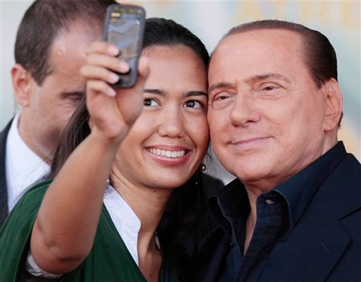 Italian Premier Silvio Berlusconi has a picture taken with a supporter at the end of his address at the People of Freedom party meeting in Rome, Sunday, Sept. 12, 2010. Berlusconi will speak to parliament at the end of the month in a highly anticipated address that could determine the fate of his government. The speech will be Berlusconi's first major parliament appearance since he split with longtime ally Gianfranco Fini. The split potentially deprived Berlusconi of his once-solid parliamentary majority, leaving the fate of his government uncertain. (AP Photo/Gregorio Borgia)        (AP)