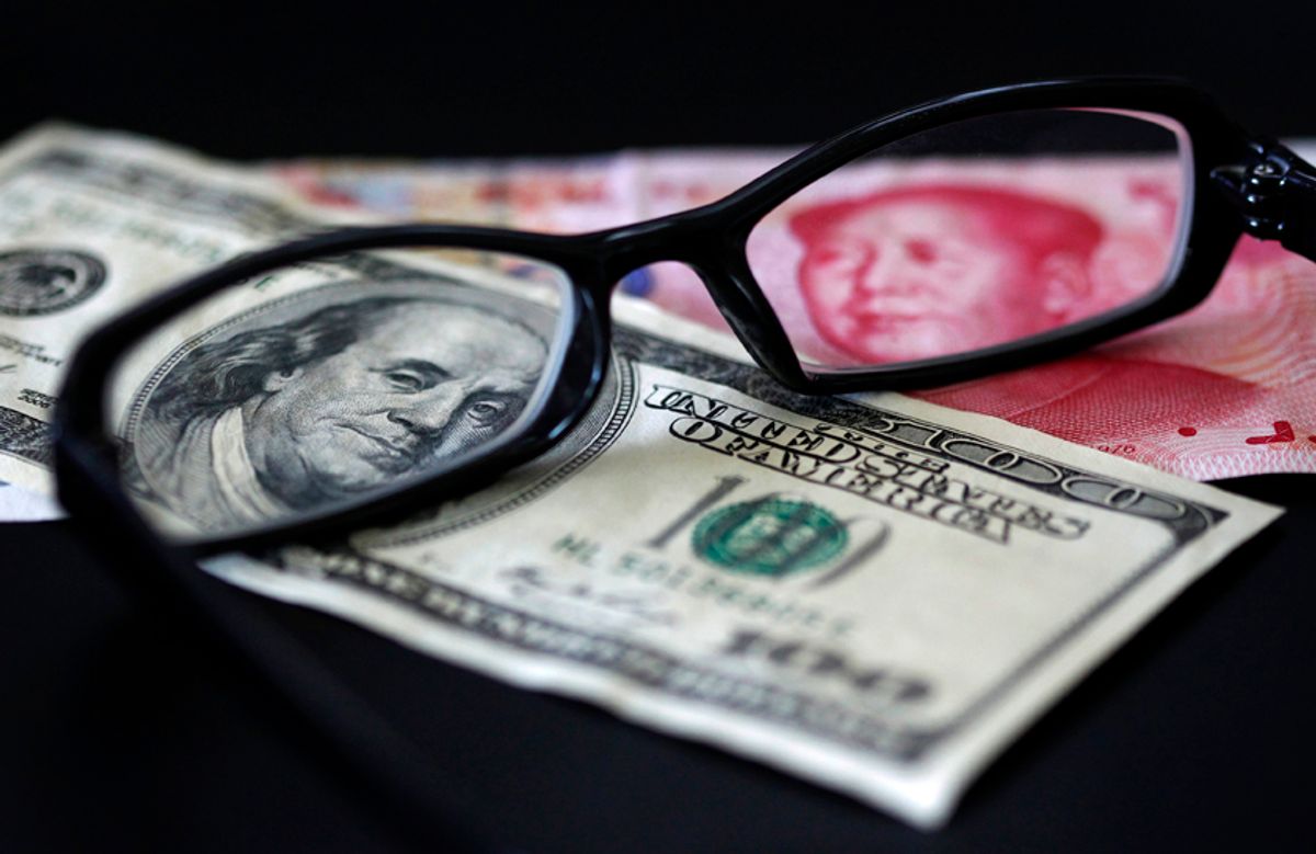 A U.S. dollar note (L) and a Chinese yuan banknote are seen through a pair of spectacles in this picture illustration taken in Taipei October 13, 2010. China's foreign exchange reserves soared in the third quarter and its trade surplus remained hefty, showing that the country is under both economic and political pressure to let the yuan rise more quickly.  REUTERS/Nicky Loh (TAIWAN - Tags: BUSINESS)  (Â© Nicky Loh / Reuters)