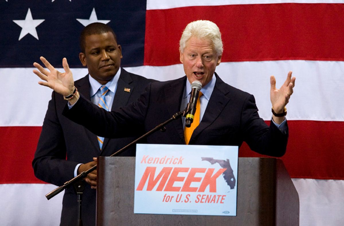 Florida Democratic senate candidate Kendrick Meek, left, listens to former President Bill Clinton address supporters during a campaign rally for Meek Tuesday, Oct. 19, 2010 in St. Petersburg, Fla. (AP Photo/Steve Nesius) (Steve Nesius)