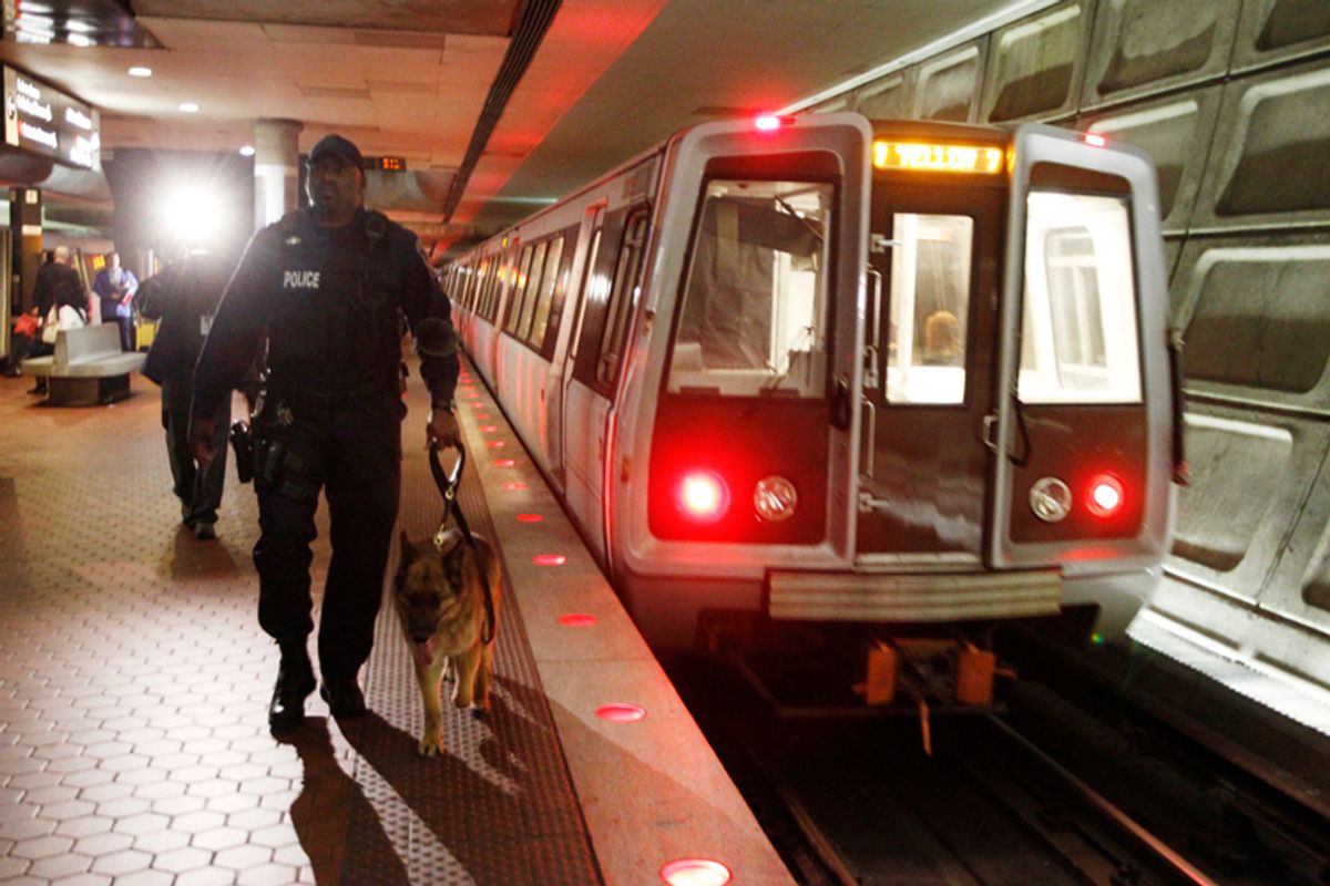 Washington Metro Transit police officer Eric Croom and his dog Kota inspect the Gallery Place-Chinatown Metro Station in Washington, March 29, 2010. Washington Metro conducted random security sweeps on Monday as part of heightened security associated with Monday's metro bomb explosions in Moscow.   REUTERS/Jason Reed   (UNITED STATES - Tags: MILITARY TRANSPORT) (Â© Jason Reed / Reuters)