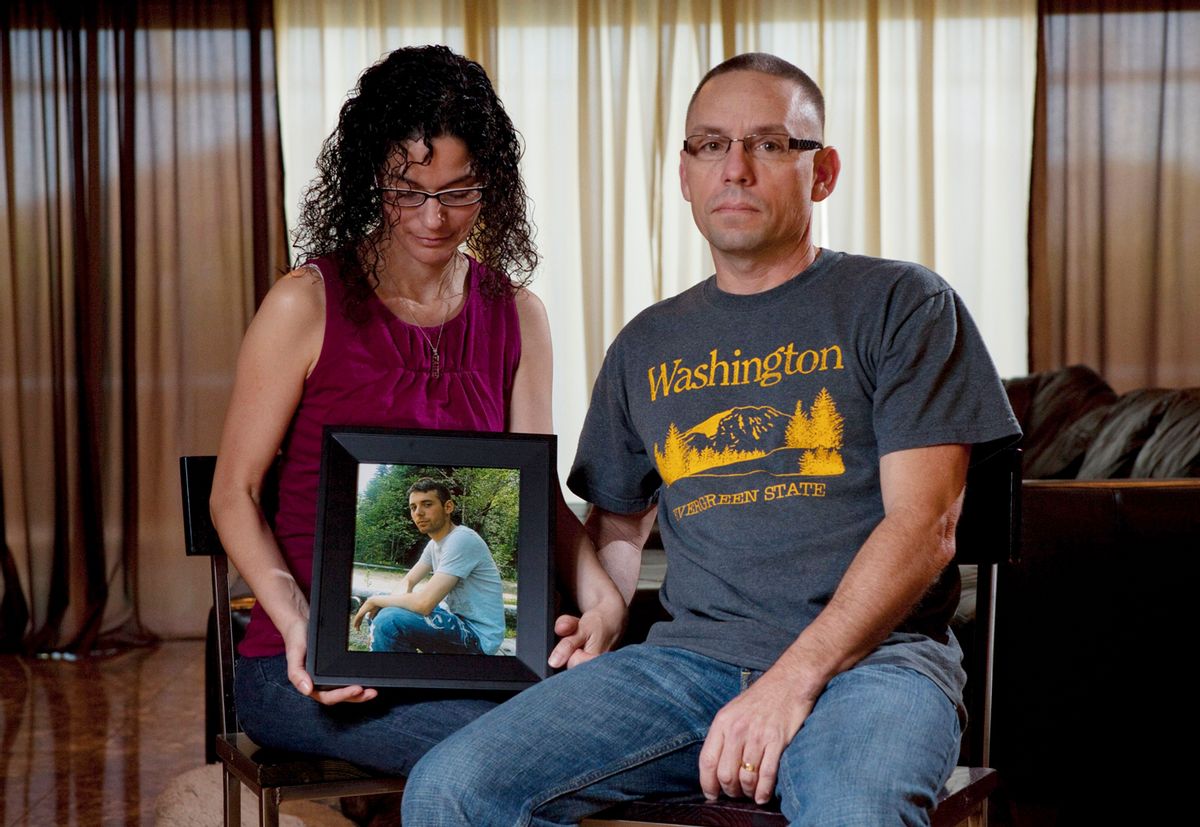 Emma and Christopher Winfield hold a photograph of their son, 22-year-old U.S. Army Spc. Adam Winfield, at their home in Cape Coral, Fla.,  Friday, Sept. 3, 2010. Adam is accused of murdering civilians during his deployment to Afghanistan, a charge he and his family firmly refute.  (AP Photo/Erik Kellar) (Erik Kellar)