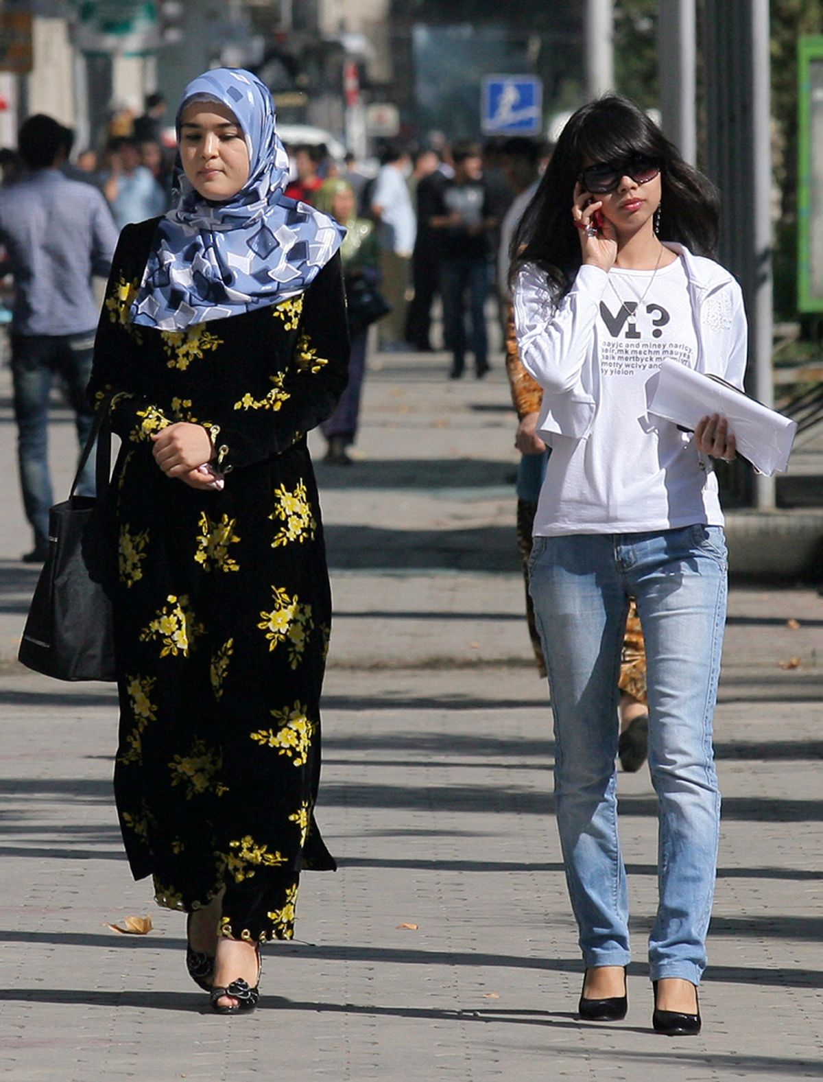 A woman, wearing a headscarf according to the Islamic dress code, walks next to a women dressed in a western style on a street of Dushanbe September 18, 2010. Chronic poverty and a Soviet-style crackdown on religion is fuelling the growth of radical Islam in parts of Central Asia, a secular but mainly Muslim region wedged between Russia, Iran, Afghanistan and China. Picture taken September 18, 2010. To match feature TAJIKISTAN-SECURITY/  REUTERS/Nozim Kalandarov  (TAJIKISTAN - Tags: RELIGION POLITICS) (Â© Nozim Kalandrov / Reuters)